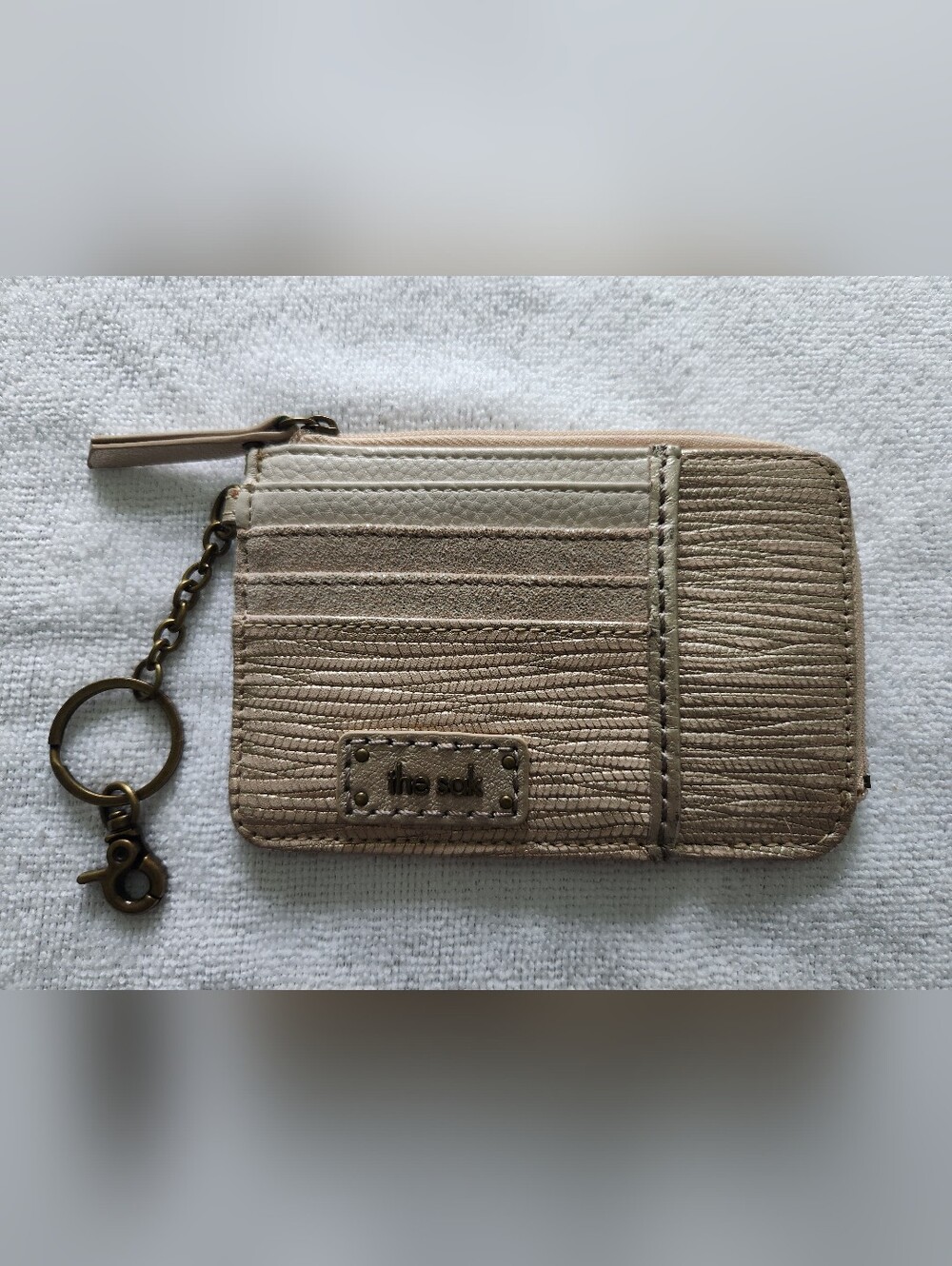 The Sak metallic champagne card wallet with wristlet